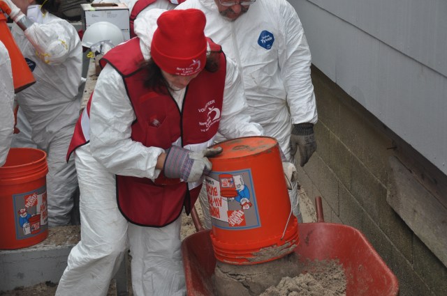 When Hurricane Sandy hit New York, New York Cares staff and volunteers sprang into action. Here, a volunteer cleans out sand from the home of a Rockaways resident who's basement had flooded.